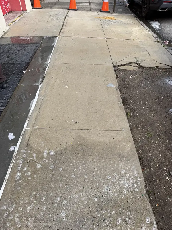 Commercial sidewalk cleaning in progress with professional surface treatment